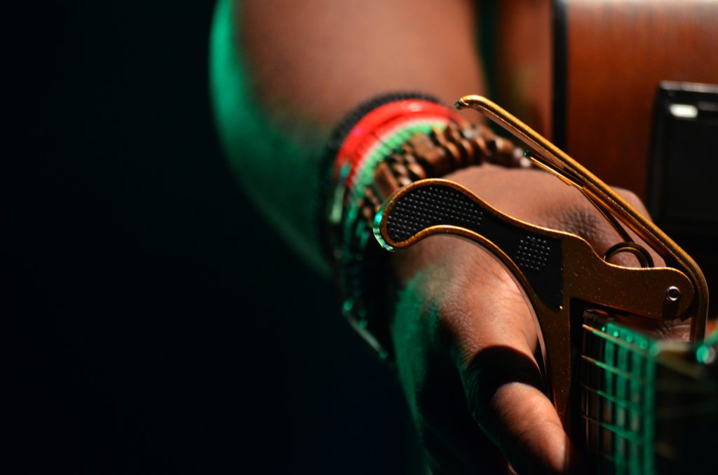 guitarist using a capo